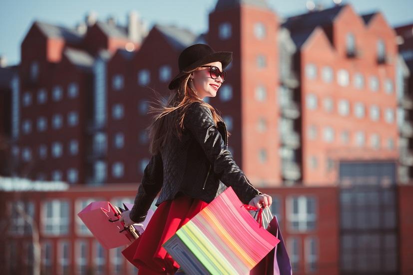 The girl walking with shopping on city streets